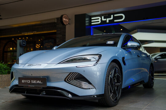 Penang, Malaysia &ndash; Mar 26, 2025: A light blue BYD Seal electric vehicle on display outside a BYD showroom, highlighting its sleek, futuristic design and front features.