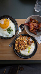 Delicious breakfast with yoghurt, fried egg and bacon