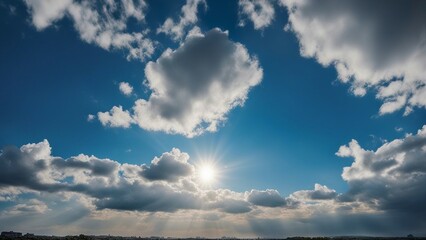 sky and clouds a clear blue sky with white fluffy clouds and sun rays wide view of a clear blue sky with some white