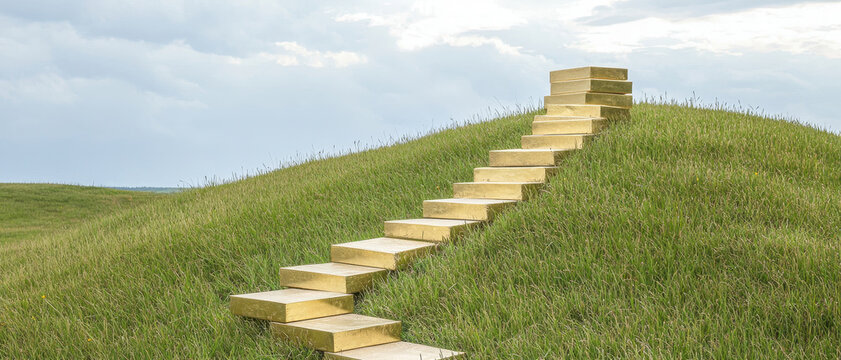 Gently sloping hill with wooden steps leading to sky, evoking sense of tranquility