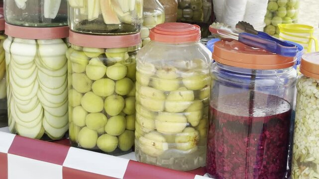 Assorted Indian Pickles and Preserves in Glass Jars at a Street Food Stall