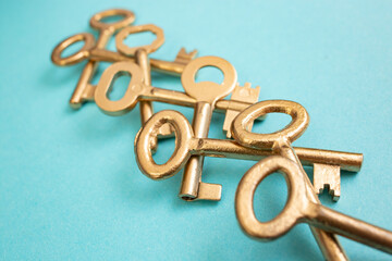 Vintage golden painted keys overlapping arranged on blue paper background