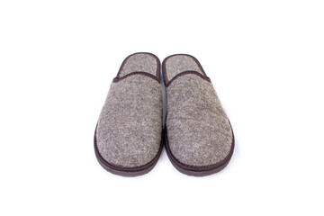 Pair of gray cozy felt slippers isolated on white background