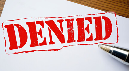 Recession and economic uncertainty, A loan application is marked as denied with a bold red stamp, symbolizing rejection and financial issues.