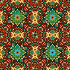 Fabulous beautiful pattern with mandalas and flowers in red, yellow and green colors. Seamless print in folk style. Ornament filling with energy.