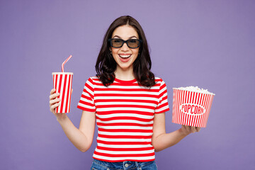 Young surprised fun woman she wear red striped t-shirt casual clothes 3d glasses watch movie film...