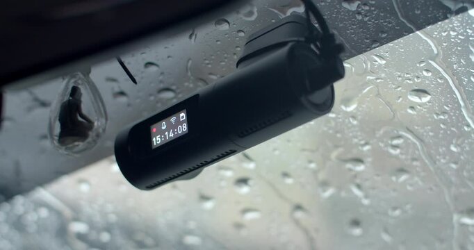 The car's front camera is recording during the rainy season.Car camera.Rain hits the glass.Heavy rain hit the glass and flowed in a stream.