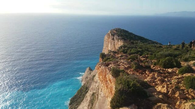 A walk along the cliff edge at sunset. Navagio Beach bay (shipwreck) on Zakynthos Island, Greece. Shot horizontally from the cliffs edge. capturing the golden light and azure waves in perfect harmony