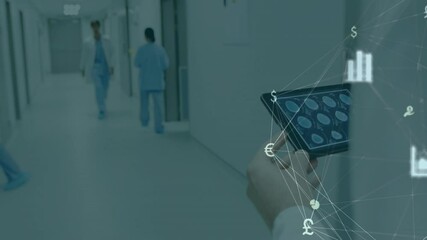 Doctor walking in hospital corridor with financial data animation overlay - Powered by Adobe