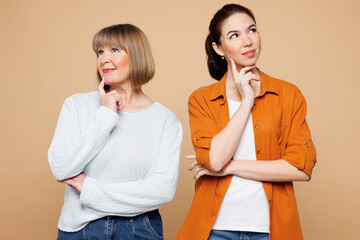 Elder parent mom 50s years old with young adult daughter two women together wear casual clothes put...