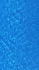 Swimming pool pattern top wiev. Blue water in the swimming pool with light reflections. Pure blue water in pool with light reflections. 