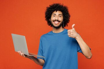 Young smiling fun IT man of African American ethnicity he wear blue t-shirt casual clothes hold use...