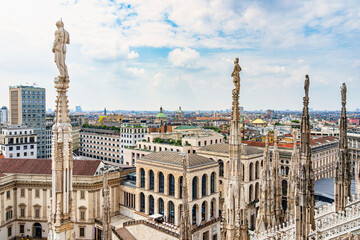 Obraz premium View of the gothic ornate spires and statues adorning the rooftop of the Milan Cathedral (Duomo di Milano) in Italy.