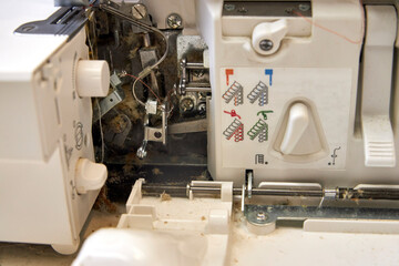 the foreman dusts off the overlock sewing machine