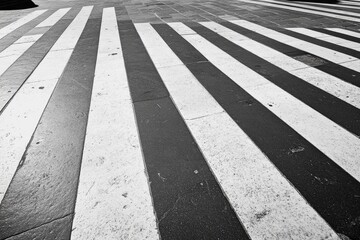 Sunlit shadows play on cafe walls around empty wooden tables, creating a peaceful and inviting urban retreat.