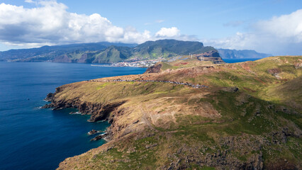 Stunning coastal landscape featuring rugged cliffs and clear blue waters, showcasing nature's beauty in a vibrant setting