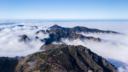 Majestic mountain landscape rising above clouds showcases nature&rsquo;s serene beauty and atmospheric wonders at dawn