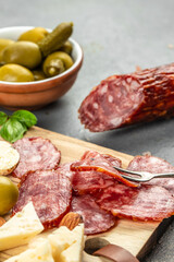 sliced dry salami on a wooden background. vertical image. place for text