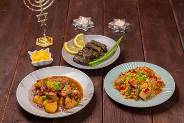Menorah lighted candles in candlesticks with the Star of David at the set table