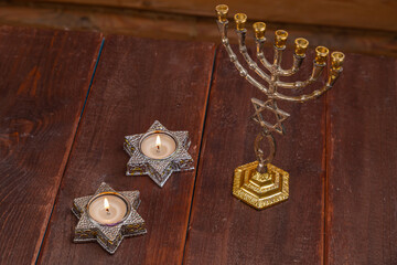 Menorah lit candles in candlesticks with the Star of David