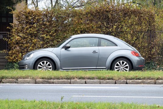 Volkswagen New Beetle A5 retro styled car parked on street, side view