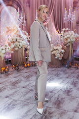 Portrait of beautiful, young woman, organizer of the wedding, on background of a beautiful decor.