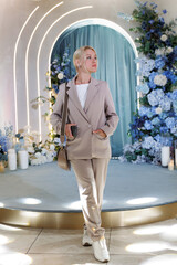 Portrait of beautiful, young woman, organizer of the wedding, on background of a beautiful decor.