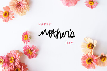 Happy Mother's Day background with light and airy minimalism style zinnia flower flat lay with pink color flowers in holiday greeting arrangement.