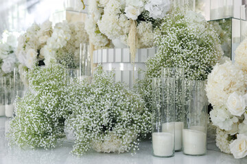 Wedding decorations made of white flowers. Decor of the ceremony and table of the bride and groom