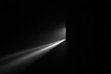 single beam of soft light cuts through dark room creating dramatic shadows and highlights