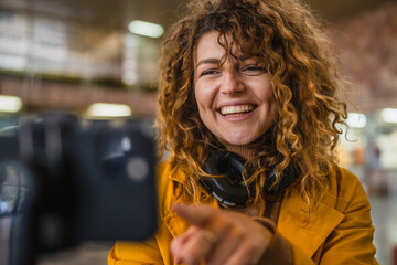 happy woman travel blog tourist record a video blog on train station