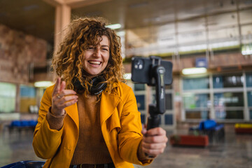 happy woman travel blog tourist record a video blog on train station