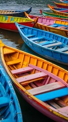 Obraz premium Colorful Boats on the Water: A vibrant cluster of colorful boats float peacefully on the tranquil water, creating a captivating scene that celebrates the beauty of water transport.