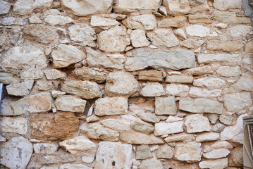 Seamless texture. A neatly laid wall of rough stone. The background is made of stone.