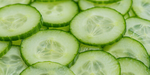 Food background. Thinly sliced cucumbers as a background.