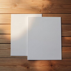 Two blank A5 sheets on light wood surface