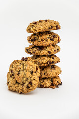 a stack of homemade oatmeal raisin cookies on a white background. Cozy and simple composition of traditional snack. bakery style poster.