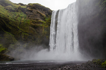 A breathtaking waterfall in Iceland flows with pure, untamed beauty—its steady rush and misty spray capturing the peaceful power of nature in this remote, magical land.