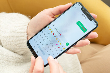 Woman's hands holding smartphone, texting 'I love you too' to 'My Love'. Close-up shows chat...
