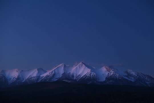 The snow-capped peaks of the High Tatras mountains in sunrise light from viewpoint Pass over Lapszanka (Pass over Łapszanka), Podhale, Poland
