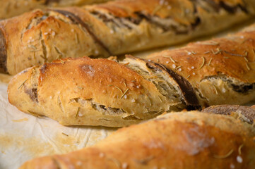 Deliciously baked artisanal bread loaves resting on parchment paper in a cozy kitchen setting