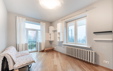 Bright Minimalist Room with Large Windows and Wooden Flooring