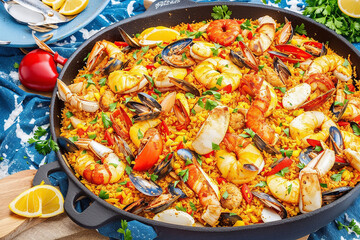 Typical spanish seafood paella. Traditional paella dish with colorful ingredients. paella with seafood. Spanish paella with seafood and saffron.