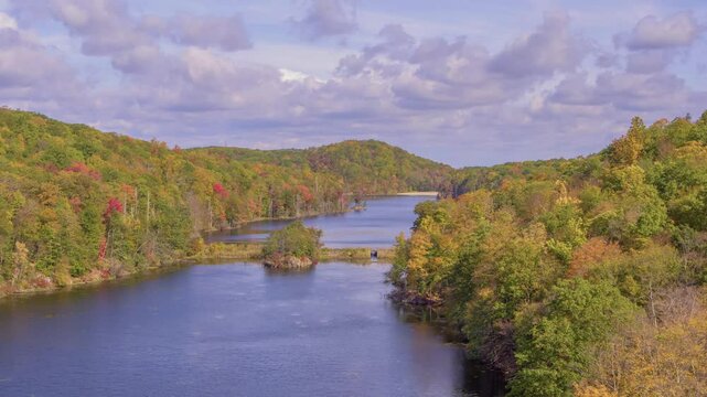 A 4K drone shot showcasing Canopus Lake in Kent, NY, during autumn, with the cloudy weather creating a peaceful and atmospheric scene.