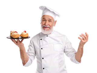 Professional pastry chef with delicious profiteroles on white background