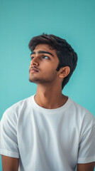 Serene Reflection: A young man gazes upward, enveloped in thought against a serene, vibrant backdrop, portraying introspection and contemplation