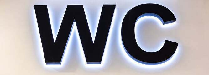 WC signboard for restroom on the wall. Entrance to a public toilet