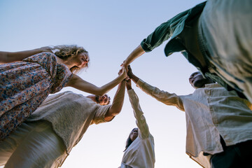 team giving high five outdoors celebrating success
