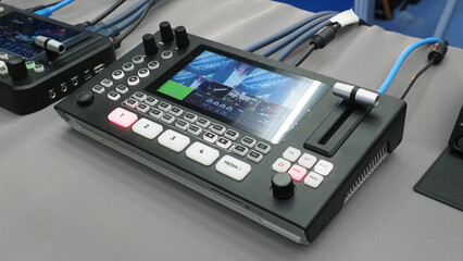 A portable video switcher with an integrated display screen.it used for live production and video mixing.