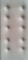 Close-up of White Leather Upholstery with Button Tufting Detailed Texture